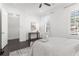Serene bedroom with dark floors, plantation shutters, a ceiling fan, and door to the bedroom's hallway entrance at 261 Thompson St, Alpharetta, GA 30009