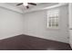 Well-lit bedroom features a ceiling fan, shuttered window, tray ceiling and beautiful, dark hardwood floors at 261 Thompson St, Alpharetta, GA 30009