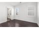 Bright bedroom with shuttered windows, dark wood floors, and an ensuite bathroom at 261 Thompson St, Alpharetta, GA 30009