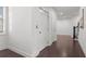 Hallway with hardwood floors, white trim and walls, and a staircase at 261 Thompson St, Alpharetta, GA 30009