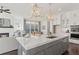 Bright, open kitchen features a large island with sink and seating, connecting to a cozy living space with a fireplace at 261 Thompson St, Alpharetta, GA 30009