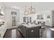 Open-concept kitchen connects seamlessly to the living area, featuring an island with seating and a view of the fireplace at 261 Thompson St, Alpharetta, GA 30009