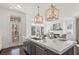 Large kitchen island with marble countertop and a view to the outdoor deck through the glass door and windows at 261 Thompson St, Alpharetta, GA 30009