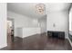 Spacious loft area with dark wood flooring, a stylish light fixture, and great lighting at 261 Thompson St, Alpharetta, GA 30009