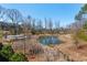 Scenic view of the pond with surrounding trees and natural landscape; houses in the background at 261 Thompson St, Alpharetta, GA 30009