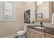 Charming powder room with decorative wallpaper, a rustic vanity, and a stylish mirror at 261 Thompson St, Alpharetta, GA 30009