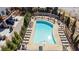 Top-down view of a sparkling swimming pool, surrounded by lounge chairs and manicured greenery at 261 Thompson St, Alpharetta, GA 30009