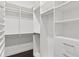 Bright walk-in closet with custom white shelves and drawers, offering ample storage space at 261 Thompson St, Alpharetta, GA 30009