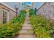 Stone steps lead through lush landscaping to the back of the home at 261 Thompson St, Alpharetta, GA 30009
