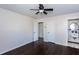 Spacious bedroom with hardwood floors, ceiling fan, and view to ensuite bathroom at 3125 Wilson Rd, Decatur, GA 30033