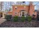 The backyard features a brick home with a grill, patio, green bushes, and dormant foliage at 4210 Gladney Dr, Atlanta, GA 30340