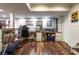 Spacious finished basement with wood flooring and a workout space with bench and desk at 4210 Gladney Dr, Atlanta, GA 30340