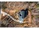 An aerial view showcases this home's private, wooded lot and long driveway at 1200 Primrose Park Rd, Sugar Hill, GA 30518