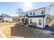 Backyard of the house featuring a covered patio and a spacious grassy lawn at 1200 Primrose Park Rd, Sugar Hill, GA 30518