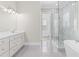 Bright bathroom features double vanities, a glass shower, and a soaking tub at 1200 Primrose Park Rd, Sugar Hill, GA 30518