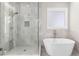 Stylish bathroom featuring a modern shower with glass door and a luxurious soaking tub at 1200 Primrose Park Rd, Sugar Hill, GA 30518