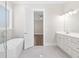 Bright bathroom with a soaking tub and double vanity at 1200 Primrose Park Rd, Sugar Hill, GA 30518