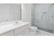 This is a full bathroom with marble floors, a white vanity and a large glass shower at 1200 Primrose Park Rd, Sugar Hill, GA 30518