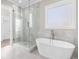 Elegant bathroom showcasing a freestanding tub and glass-enclosed shower at 1200 Primrose Park Rd, Sugar Hill, GA 30518