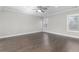 Large bedroom with wood floors, natural light, and ceiling fan at 1200 Primrose Park Rd, Sugar Hill, GA 30518