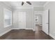 Bedroom with dark wood floors and a view into the hallway at 1200 Primrose Park Rd, Sugar Hill, GA 30518