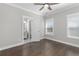 Bedroom features wood floors, and a view into the bathroom at 1200 Primrose Park Rd, Sugar Hill, GA 30518