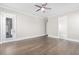 Bright bedroom provides hardwood floors, neutral walls, ceiling fan and natural light at 1200 Primrose Park Rd, Sugar Hill, GA 30518