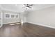 Spacious bedroom featuring hardwood floors, recessed lighting, ceiling fan, and natural light from multiple windows at 1200 Primrose Park Rd, Sugar Hill, GA 30518