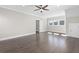 Bright bedroom showcasing beautiful hardwood floors, ceiling fan, recessed lighting, and natural light at 1200 Primrose Park Rd, Sugar Hill, GA 30518