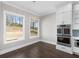 This is a dining space with hardwood floors, stainless appliances, and large windows at 1200 Primrose Park Rd, Sugar Hill, GA 30518