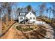 Front exterior view of a home with a well-maintained lawn and long driveway at 1200 Primrose Park Rd, Sugar Hill, GA 30518