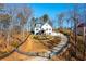 Exterior of the home featuring a long driveway and well-manicured front yard at 1200 Primrose Park Rd, Sugar Hill, GA 30518