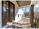 Brick steps lead to a covered porch featuring a dark wood door, columns, and a stylish brick floor at 1200 Primrose Park Rd, Sugar Hill, GA 30518