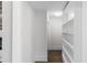 Bright hallway featuring hardwood floors and built-in shelving, providing a clean and organized transition at 1200 Primrose Park Rd, Sugar Hill, GA 30518