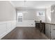 Bright hallway features hardwood floors, wainscoting, natural light and wrought iron railing at 1200 Primrose Park Rd, Sugar Hill, GA 30518
