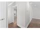 Bright hallway featuring hardwood floors and white trim at 1200 Primrose Park Rd, Sugar Hill, GA 30518