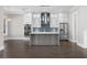 Spacious, open-concept kitchen featuring a center island, stainless steel appliances, and stylish pendant lighting at 1200 Primrose Park Rd, Sugar Hill, GA 30518