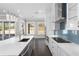 A kitchen featuring an island, stainless steel appliances, stylish pendant lighting, and backyard views at 1200 Primrose Park Rd, Sugar Hill, GA 30518