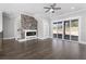 Spacious living room featuring a modern fireplace, built-in shelving, and sliding doors at 1200 Primrose Park Rd, Sugar Hill, GA 30518