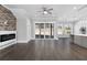 Open-concept living room featuring a modern fireplace, sliding doors to the backyard, and seamless flow to the kitchen at 1200 Primrose Park Rd, Sugar Hill, GA 30518