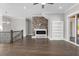 Bright living room with hardwood floors, a brick fireplace, and built-in bookshelves at 1200 Primrose Park Rd, Sugar Hill, GA 30518