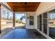 Covered patio with dark wood floors, wood columns, brick siding, ceiling fan, and sliding glass doors at 1200 Primrose Park Rd, Sugar Hill, GA 30518