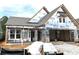New construction home featuring a covered porch, white trim, and unfinished garage space at 138 Laurel Farms Ln, Dallas, GA 30157