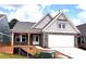 Charming single-story home featuring brick accents, attached garage, and a covered front porch at 138 Laurel Farms Ln, Dallas, GA 30157
