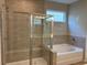 Bathroom featuring tile shower with glass door and separate soaking tub at 125 Laurel Farms Ln, Dallas, GA 30157