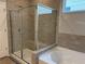 Modern bathroom featuring a tiled shower with glass door and a soaking tub at 125 Laurel Farms Ln, Dallas, GA 30157