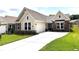 Charming single-story home featuring a manicured lawn, stone accents, and a two-car garage at 125 Laurel Farms Ln, Dallas, GA 30157