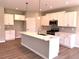 Bright kitchen with white cabinetry, a marble island, stainless steel appliances, and wood floors at 125 Laurel Farms Ln, Dallas, GA 30157