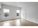 Cozy bedroom featuring hardwood floors, ample natural light from two windows, and a convenient closet at 2733 Caldwell Rd, Brookhaven, GA 30319