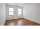 Bright bedroom with hardwood floors, two windows, and neutral paint, creating a serene and inviting space at 2733 Caldwell Rd, Brookhaven, GA 30319